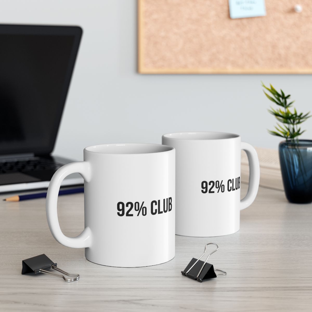 Two white mugs on a table with the words 92% Club written on the front.