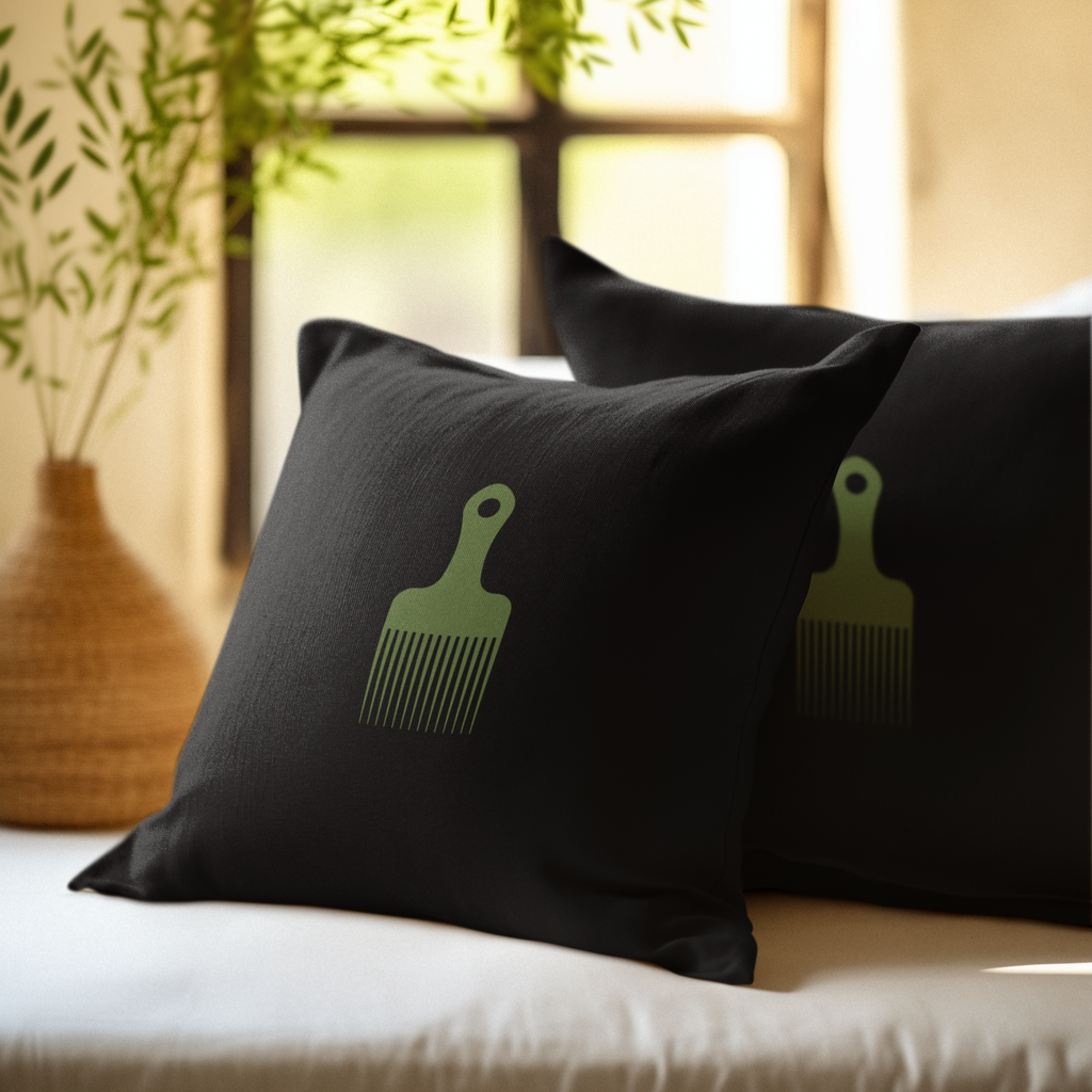 Two Black throw pillows with a green afro pick on the front.