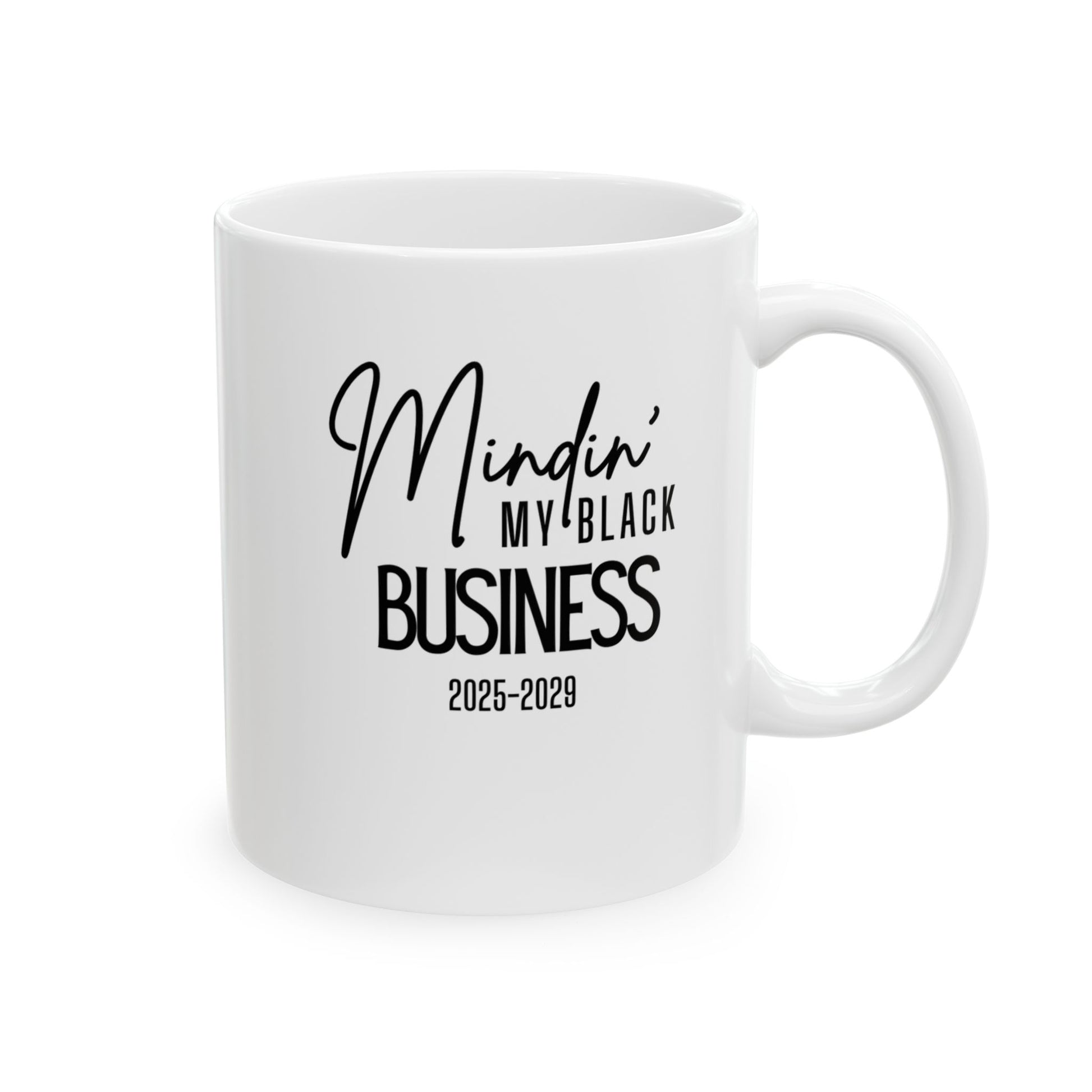 White 11oz mug with the words minding my black business 2025-2029.