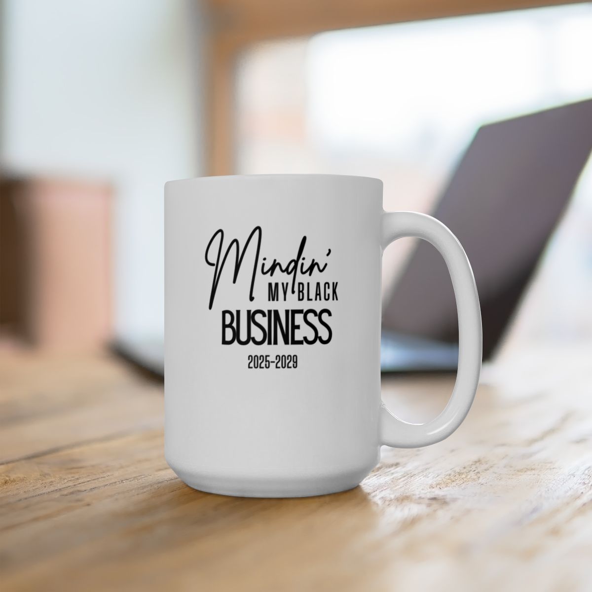 White mug with the words mindin my black business 2025-2029 written in Black on the front of the mug.