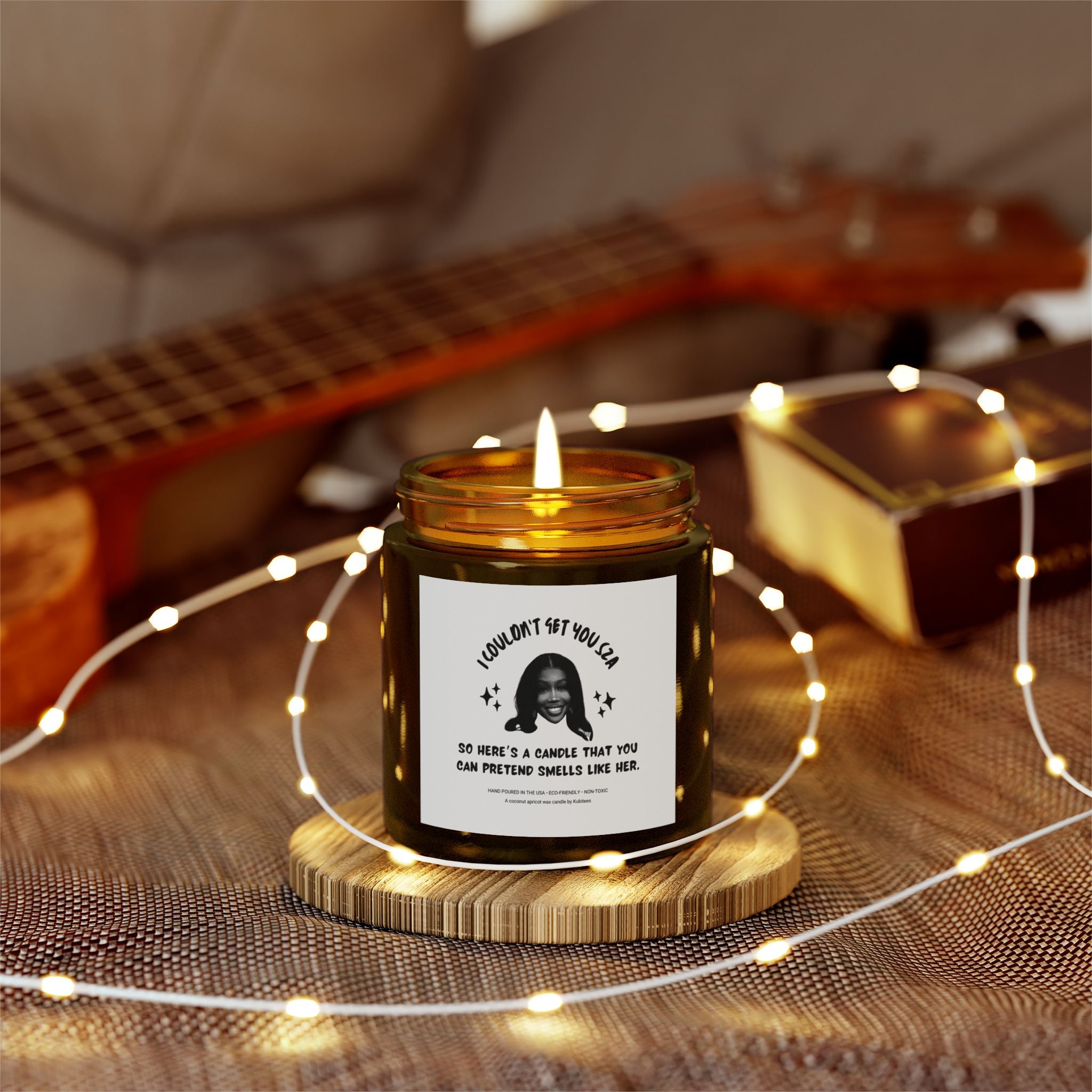 Decorative lights enwrapping a brown candle jar with a picture of SZA and some words on the front.